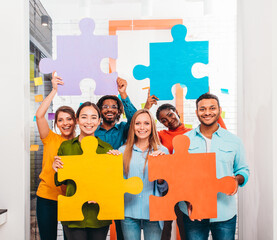 Teamwork of partners that work with puzzle as integration and startup concept