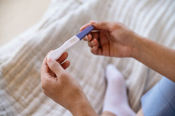 Afro american woman holding negative pregnancy test in hands