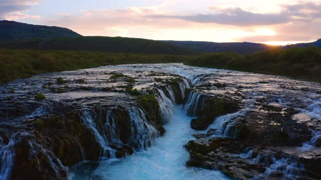 4k drone forward video (Ultra High Definition) of Bruarfoss Waterfall, secluded spot with cascading blue waters. Impressive morning scene of Iceland, Europe. Beauty of nature concept background..