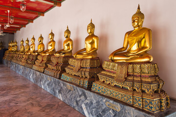 Row of sitting Buddha's in Wat Pho, Bangkok, Thailand.