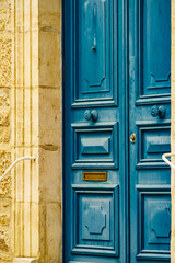 Stone house with wooden blue door.