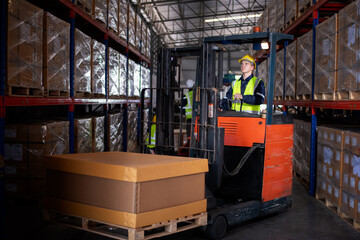 Worker industry factory wear safety uniform factory drive forklift truck moving goods boxes to industry production in factory warehouse area is industry manufacturing transportation concept.