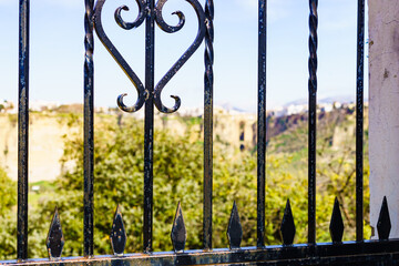Old gate and Ronda town in distance, Spain.