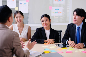 Businessmen smile, clap and shake hands during business meetings.