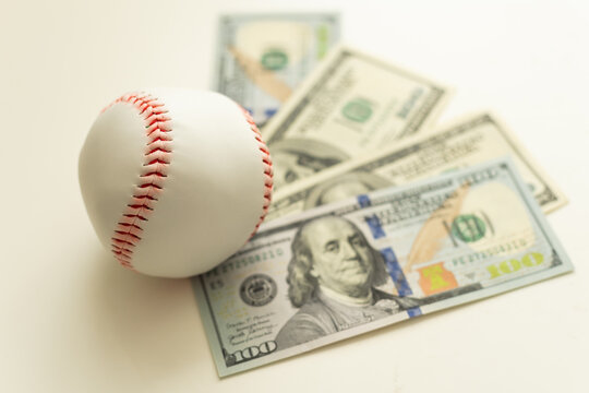 Baseball with cash money. Major league strike, lockout and sports betting concept.