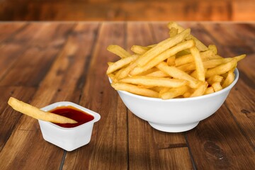 plate of hot tasty french fries with red ketchup
