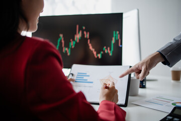 Two investors look at stock insights to analyze risk, stock investing businessman analyzing stock market rise and fall chart, stock market investor, profit making. investment concept.