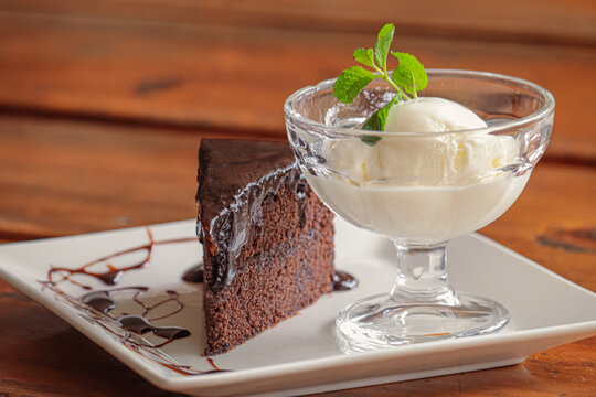 Chocolate fudge cake slice served with vanilla ice cream. Could be used for pictures in menu card.