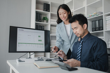 Two people looking at datasheets of marketing and sales results, analysis of business results jointly between executives, department heads and employees to brainstorm company sales management.