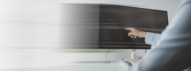 Female programmer typing on computer keyboard, programmer designing custom computer programming, coding programs and websites. Computer programming design concepts.