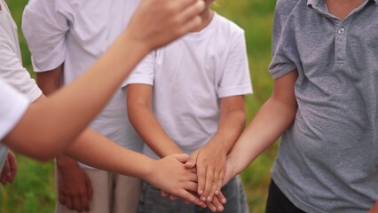 children stand in a circle and hold hands as a team. happy family childhood dream concept. little...