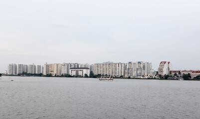Fototapeta na wymiar A Stunning view of the Kochi cityscape with high rise buildings against the cloudscape viewed from the Arabian sea in Kerala, India.