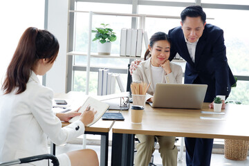 Businessmen and employees working at desks in the office.