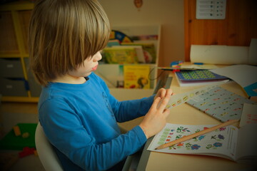 child is making a paper plane