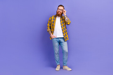 Full length photo of successful smart man wear stylish clothes hand touch eyewear watching empty space isolated purple color background