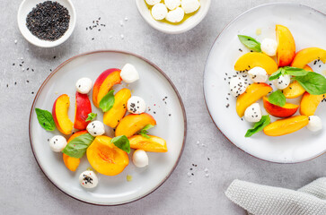 Grilled Peach Salad with Mozzarella Pearls on Bright Concrete Background