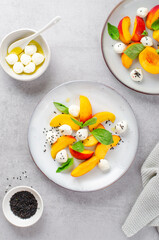 Grilled Peach Salad with Mozzarella Pearls on Bright Concrete Background