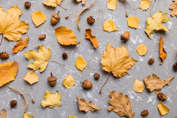 Autumn composition. Pattern made of dried leaves and other design accessories on table. Flat lay, top view