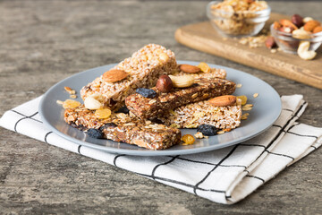 Various granola bars on table background. Cereal granola bars. Superfood breakfast bars with oats, nuts and berries, close up. Superfood concept