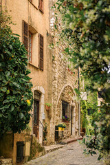 Fototapeta na wymiar Traditional old stone houses on a street in the medieval town of Saint Paul de Vence, French Riviera, South of France