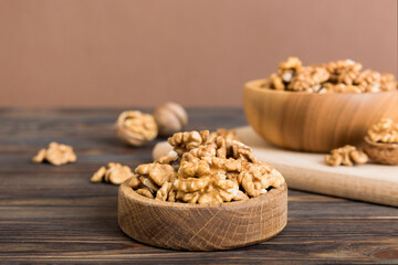 Fresh healthy walnuts in bowl on colored table background. Top view Healthy eating bertholletia concept. Super foods