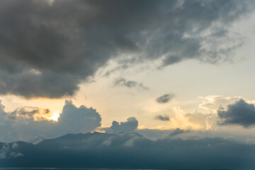Sunset view of Lake Maninjau, West Sumatra, Indonesia. Evening sun, clouds and mountains.