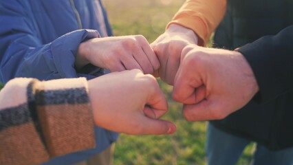 close-up fists a join together team. business team teamwork concept. close-up hands fists together group of people. team of young lifestyle tourists fists together success business concept