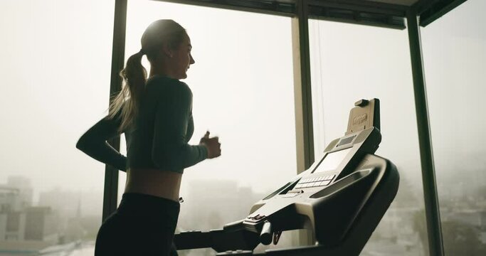 Gym, window or woman running on treadmill machine in agility training, exercise or cardio workout. Active runner, challenge or girl athlete with fitness for health, speed development or wellness