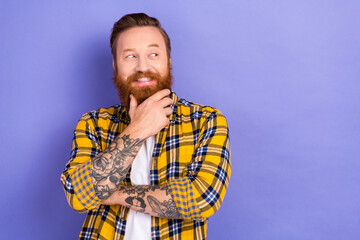 Portrait of minded creative cheerful man hand touch beard chin look interested empty space isolated...
