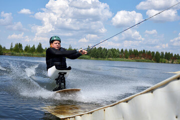 Action shot of young man with disability enjoying wakeboarding on ramp, copy space