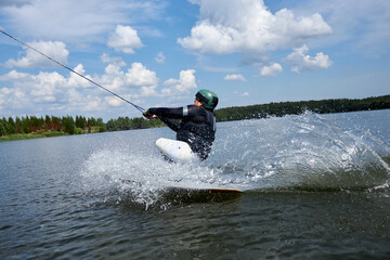 Action shot of young man with disability doing extreme water sports outdoors