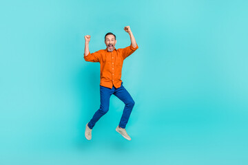 Fototapeta na wymiar Full body length size photo of jumping overjoyed crazy businessman pensioner have fun fists up triumph isolated on cyan color background
