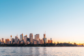 Beautiful Sydney city skyline at sunset viewed from Royal Botanic Garden, NSW, Australia