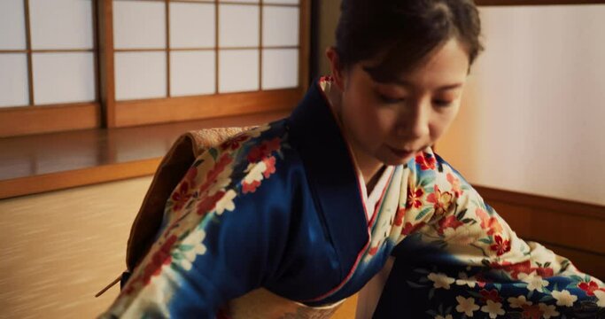 Close Up Portrait of a Focused Adult Female Playing on a Traditional Japanese Toto Instrument. Musician Wearing a Beautiful Kimono, Performing a Classical Solo Concert Indoors in Japan