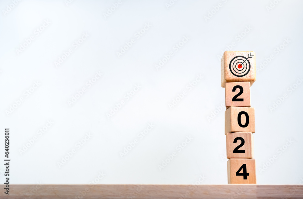 Poster 2024 happy new year background. target dart icon on wood on top of 2024 year numbers on wooden cube 