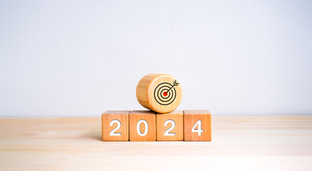 The calendar year 2024 with goal and success concept. Big wood target dart icon and 2024 new year...