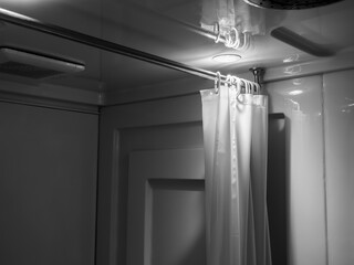 White clean narrow bathroom interior with curtain partition at shower area, wet zone. Modern design...