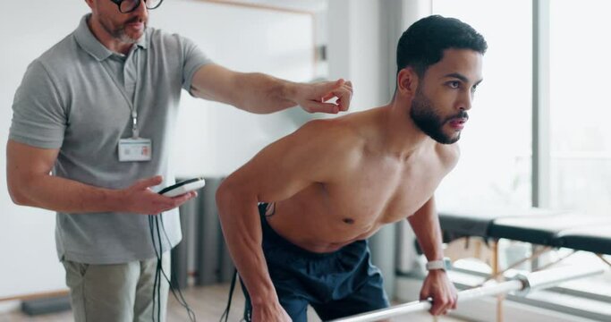 Man with electrical muscle stimulator for physiotherapy exercise, training and health performance. Healthcare, physical therapy and physiotherapist with machine to test patient weightlifting strength