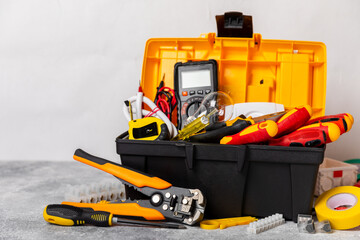 Electrician equipment on marble background with copy space.Top view.Electrician tool set.Multimeter, tester,screwdrivers,cutters,duct tape,lamps,tape measure and wires.Flet lay. Construction concept. © Avocado_studio