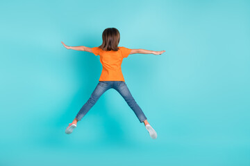 Fototapeta premium Back rear view photo of funky girl wear trendy clothes jump up fly air rejoice seasonal sale discount isolated on cyan color background