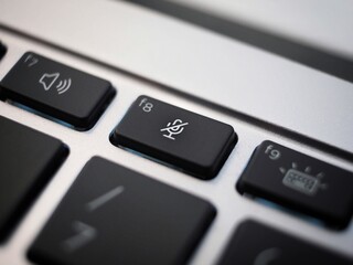 black mute key closeup on a laptop keyboard