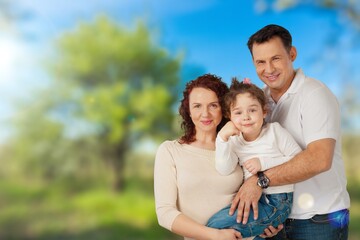 Fototapeta premium Happy young family walking together outdoor