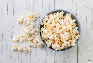Popcorns on a bowl over wooden table