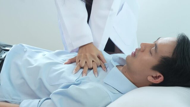 4k slow motion of asian female doctor specialist and male patient reduced suspension for performing CPR on asthma patient, epilepsy and unconsciousness