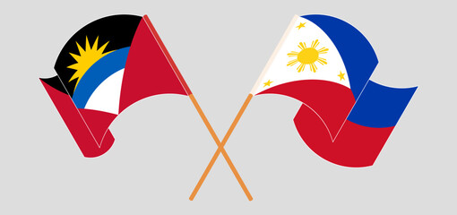 Crossed and waving flags of Antigua and Barbuda and the Philippines