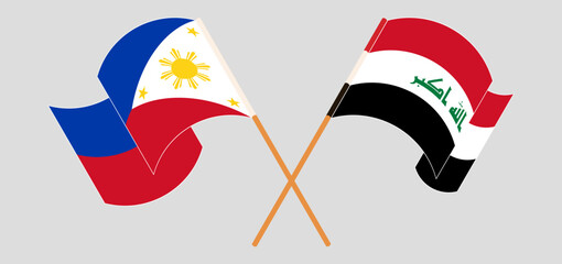 Crossed and waving flags of the Philippines and Iraq