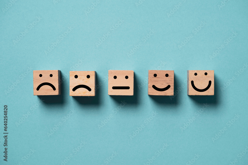 Aufkleber human face from sad to smile print screen on wooden block cube face on blue background for positive 