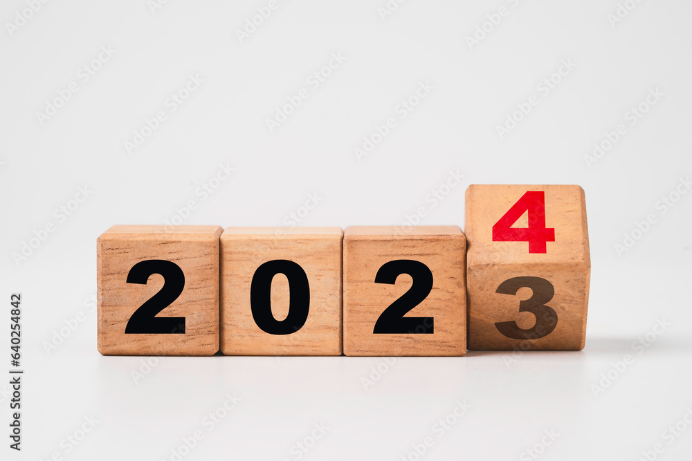 Poster flipping of 2023 to 2024 on wooden block cube for preparation merry christmas and happy new year cha