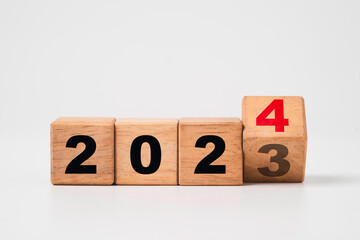 Flipping of 2023 to 2024 on wooden block cube for preparation merry Christmas and happy new year...