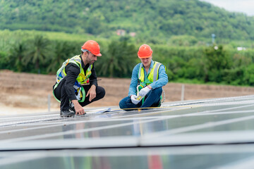 Professional specialist technician engineer working to maintenance checking and installing solar roof panel on the factory rooftop under sunlight. Worker inspection team for smart grid ecology energy